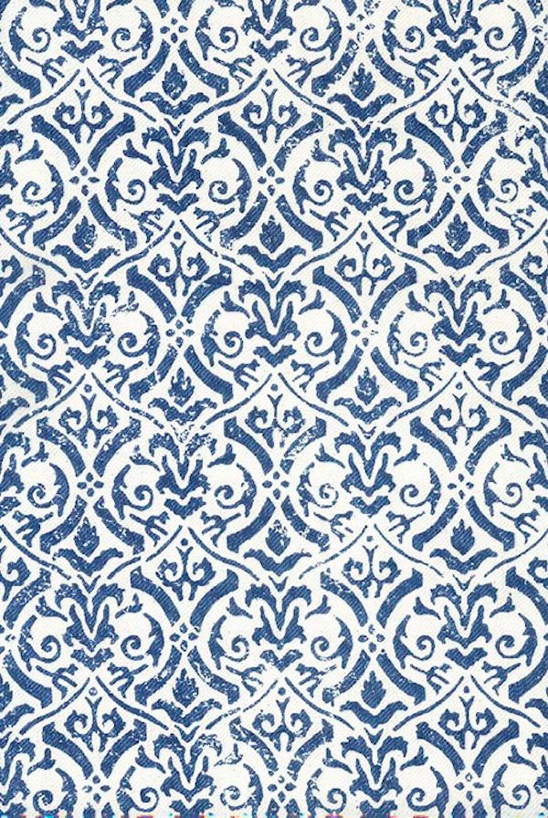 Detail of fabric in a botanical damask print in navy on a white field.