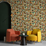 A pair of armchairs in front of a wall papered in a repeating building print in shades of blue, orange, red and green. 