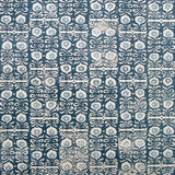 Wallpaper in a repeating damask print in blue-gray and white on a navy field.