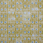 Wallpaper in a repeating damask print in blue and white on a mustard field.