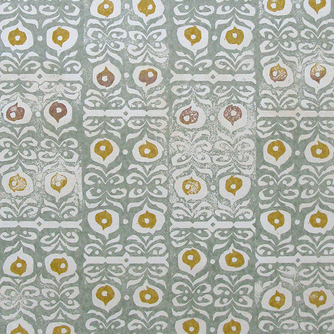 Fabric in a repeating damask print in white and gold on a blue-gray field.