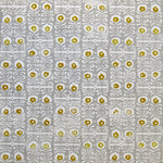 Wallpaper in a repeating damask print in mustard and white on a gray field.