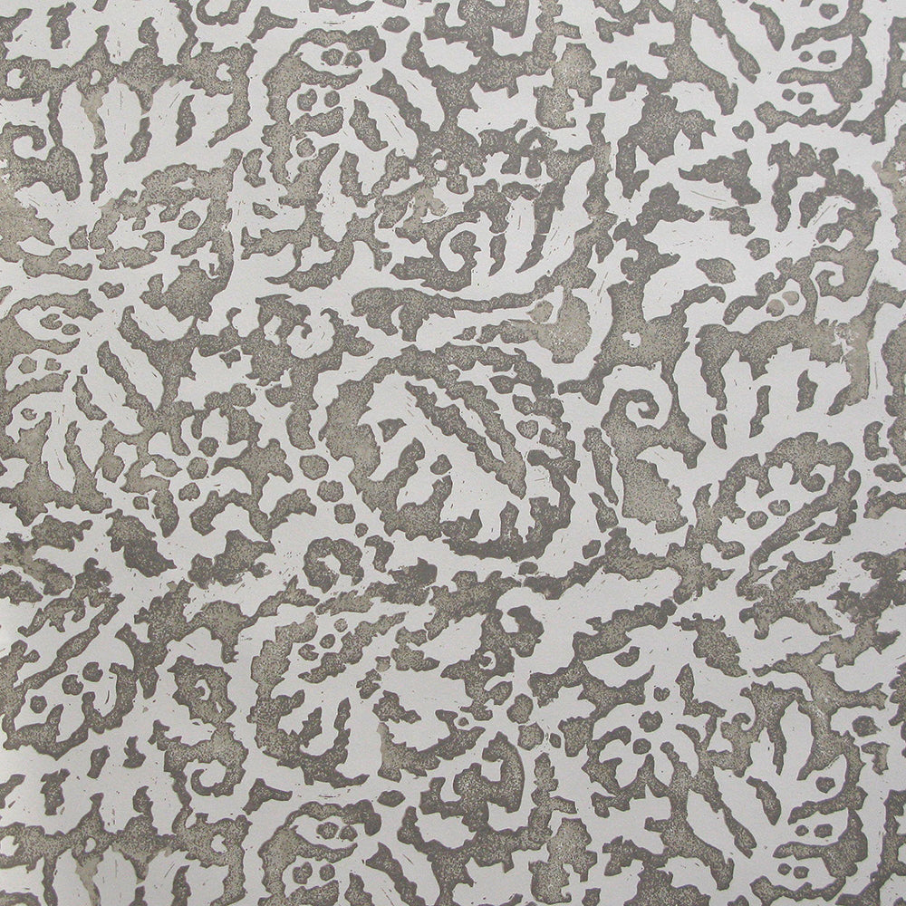 Wallpaper in a botanical paisley print in white on a light brown field.