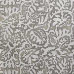 Wallpaper in a botanical paisley print in white on a light brown field.