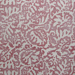 Wallpaper in a botanical paisley print in white on a dusty rose field.