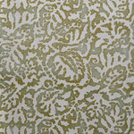 Wallpaper in a botanical paisley print in cream on a mottled tan field.