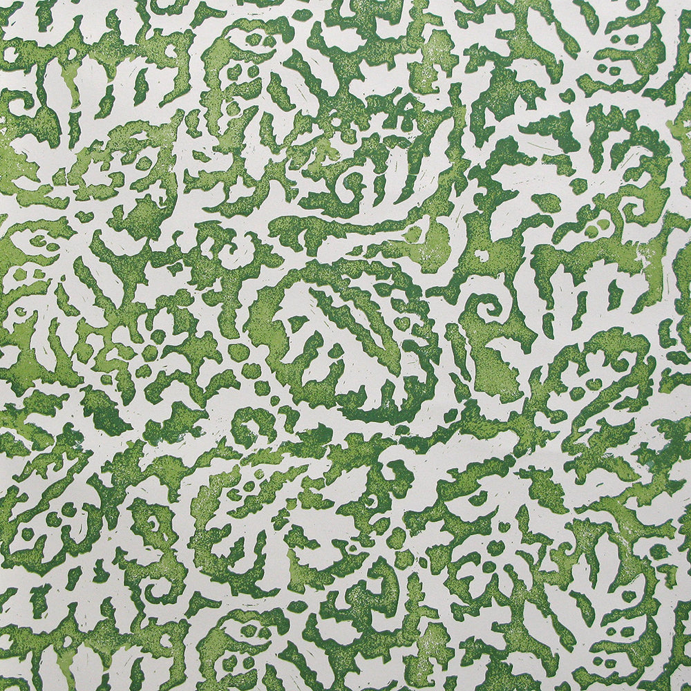 Wallpaper in a botanical paisley print in white on a mottled green field.