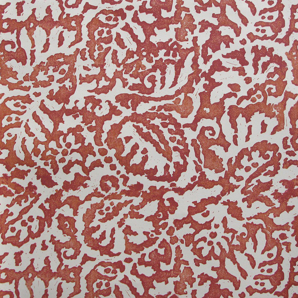 Wallpaper in a botanical paisley print in cream on a mottled red field.