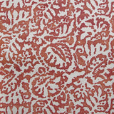 Wallpaper in a botanical paisley print in cream on a mottled red field.