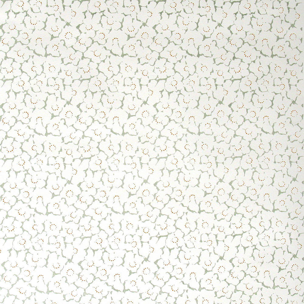 Wallpaper in a minimal floral print in rust and light green on a cream field.