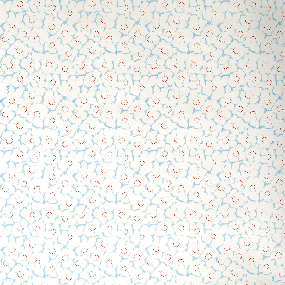 Wallpaper in a minimal floral print in light blue and red on a cream field.