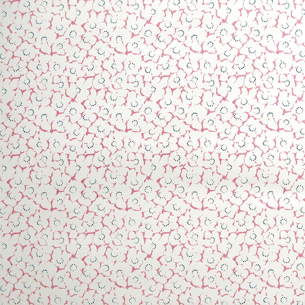 Wallpaper in a minimal floral print in navy and pink on a cream field.