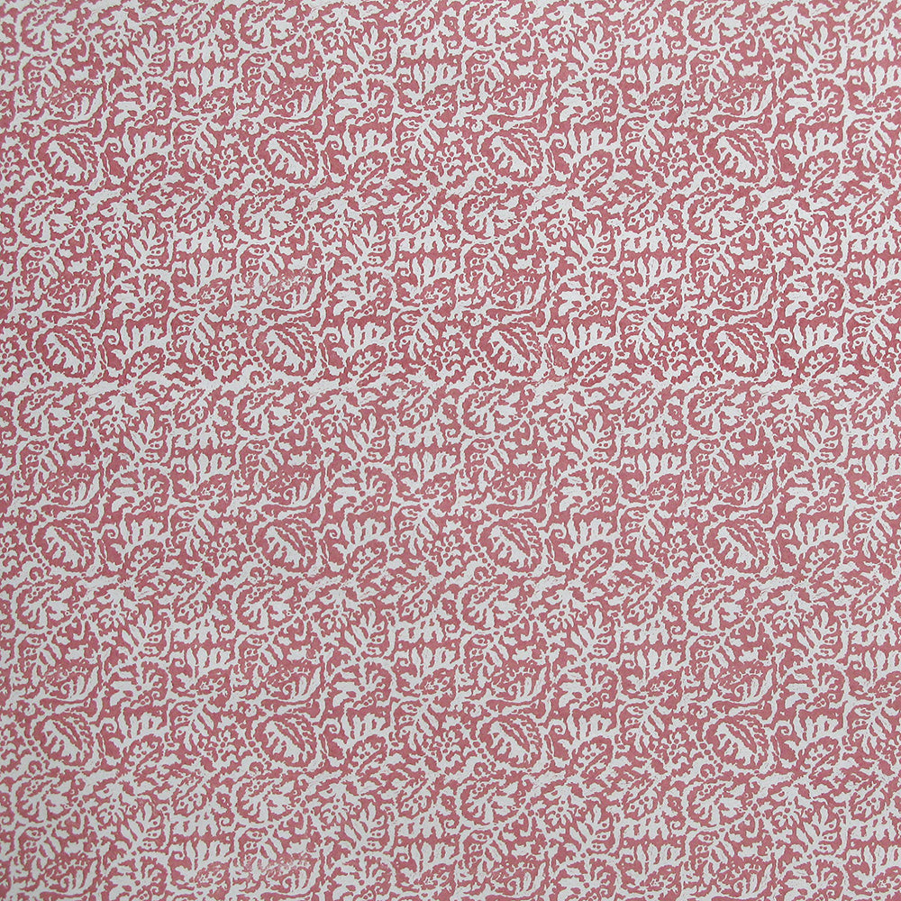 Detail of wallpaper in a dense paisley print in white on a dusty rose field.
