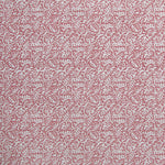 Detail of wallpaper in a dense paisley print in white on a dusty rose field.