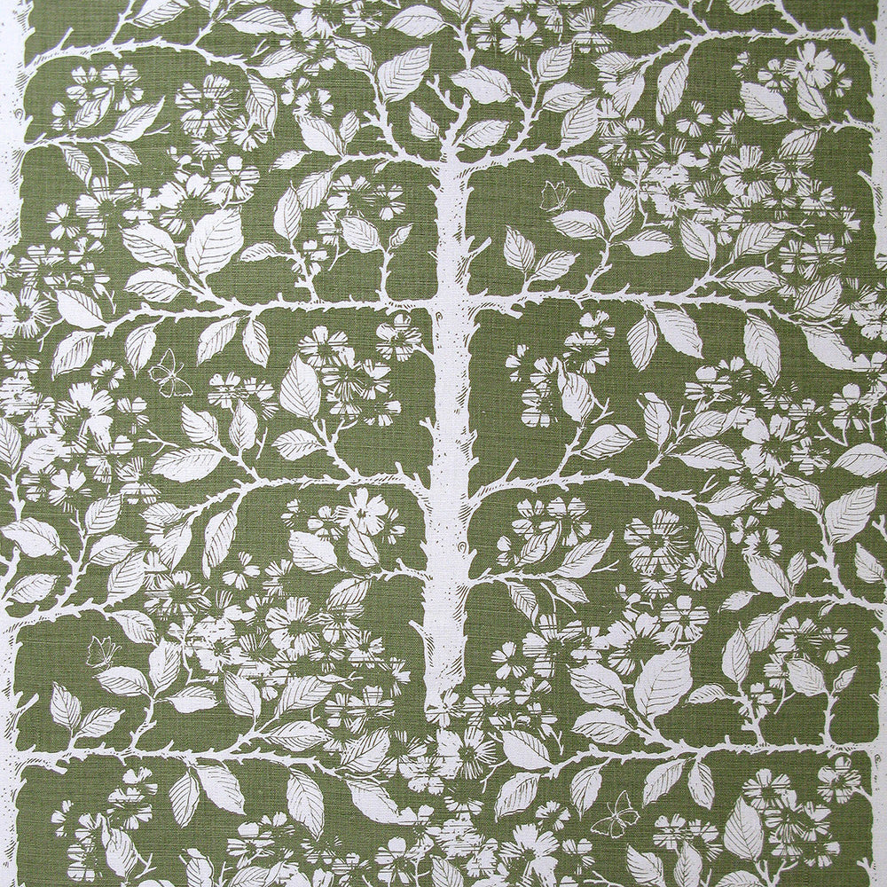 Detail of wallpaper in a large-scale tree and leaf print in white on a sage field.