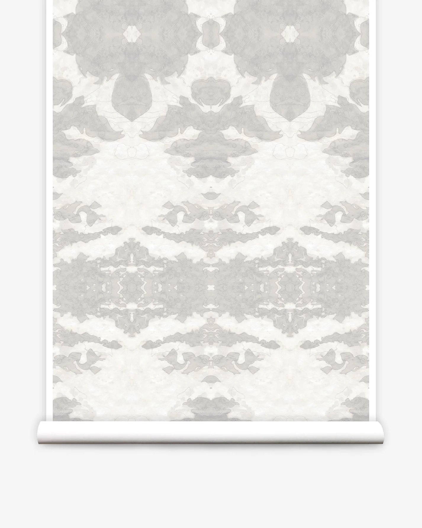 Partially unrolled wallpaper yardage in a painterly ikat print in shades of gray and cream.