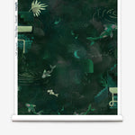 Partially unrolled wallpaper yardage in a playful koi pond print in shades of green and yellow on a black field.