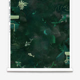 Partially unrolled wallpaper yardage in a playful koi pond print in shades of green and yellow on a black field.