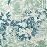 Detail of wallpaper in an intricate botanical, bridge and house print in turquoise and navy on a cream field.