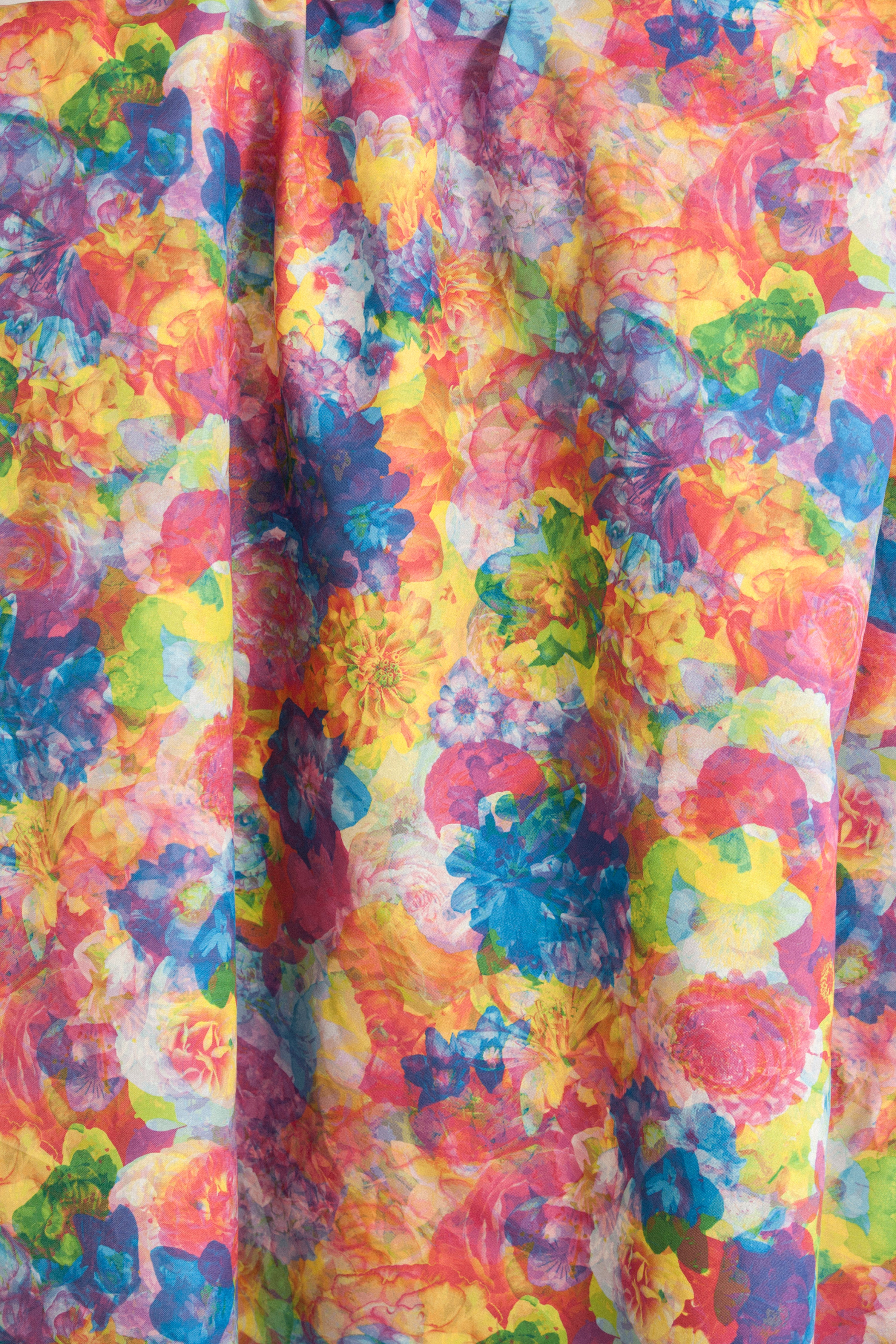 Draped fabric yardage in a dense photorealistic floral print in multicolor neon shades.