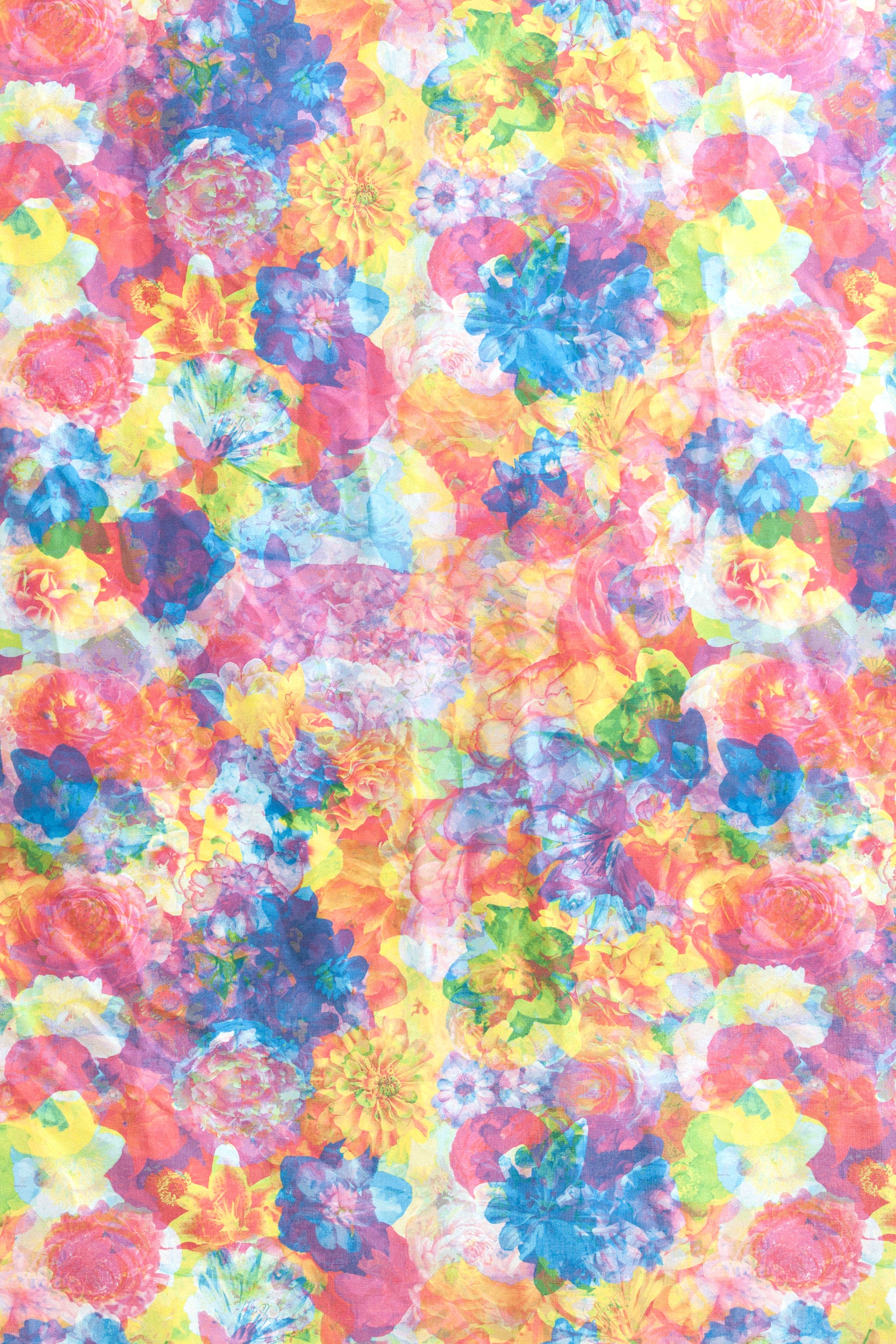 Detail of fabric in a dense photorealistic floral print in multicolor neon shades.