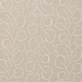 Woven fabric swatch with a large-scale repeating leaf print in white on a cream background.