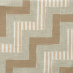 Close-up of fabric in a playful zigzag stripe print in shades of brown, gray and white.