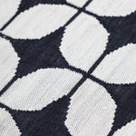 Alhambra Rug in black and white featuring a pattern of linked circles that create a star like lattice