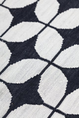 Alhambra Rug in black and white featuring a pattern of linked circles that create a star like lattice
