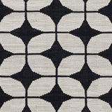 Detail of Alhambra Rug in black and white a featuring a pattern of linked circles that create a star like lattice.
