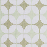 Detail of Alhambra Rug in Olive featuring pattern of linked circles that create a star like lattice in a soft olive and lime green on an ivory field. 