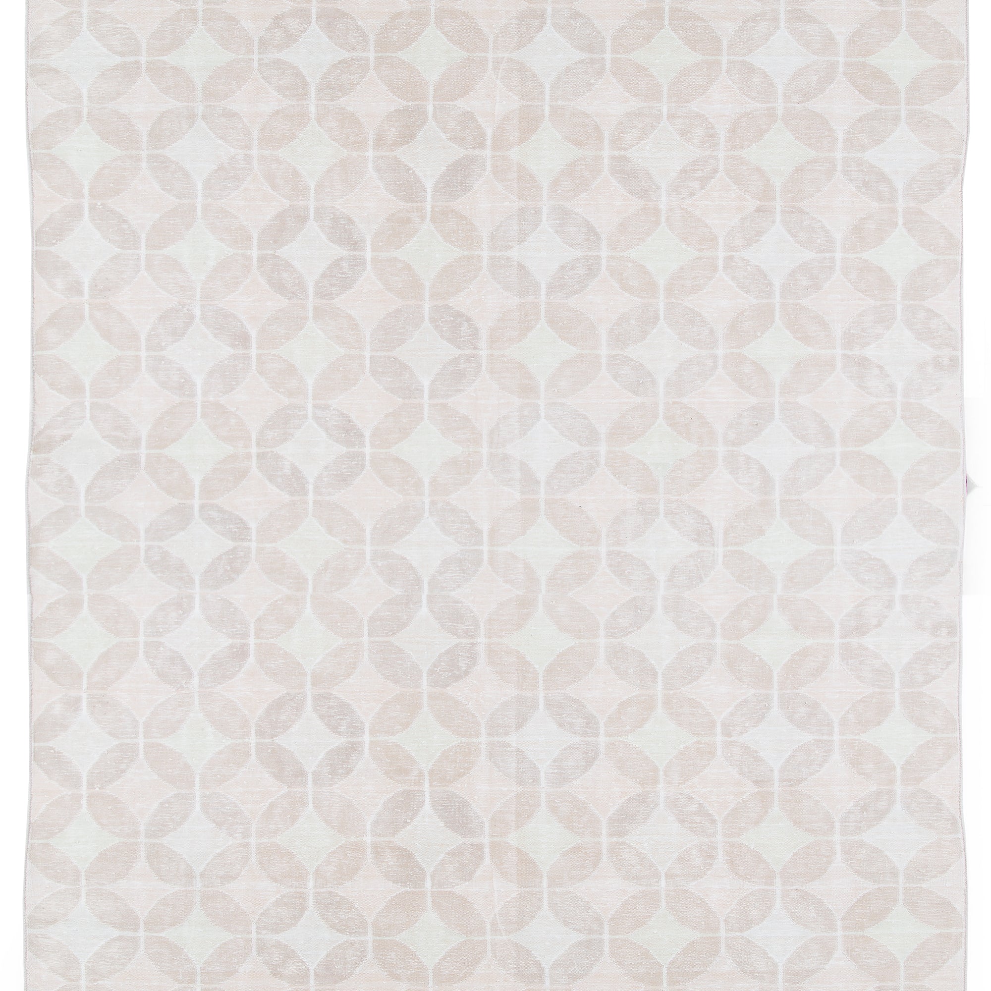 Full size Alhambra Rug in Stonewash featuring pattern of linked circles that create a star like lattice in a range of pale pink tones a soft white field. 