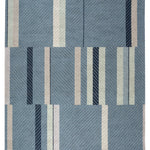 Full size Amelia Rug in Lapiz featuring a minimalist broken stripe pattern, overlayed with thin light blue diagonal lines. The broken stripes are a mix of navy blue, pale blue. white and turquoise with black accents, all on denim blue field.
