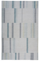 Full size Amelia Rug in Pearl featuring a minimalist broken stripe pattern, overlayed with thin white diagonal lines. The broken stripes are a mix of pale blues, grey, and turquoise with slate grey accents, all on a pale grey field. 