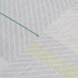 Detail of the Amelia Rug in Peridot featuring a minimalist broken stripe pattern, overlayed with thin white diagonal lines. The broken stripes are a mix of white, grey, and shades of yellow with kelly green accents, all on a light grey field. 