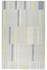 Full size Amelia Rug in Peridot featuring a minimalist broken stripe pattern, overlayed with thin white diagonal lines. The broken stripes are a mix of white, grey, and shades of yellow with kelly green accents, all on a light grey field. 