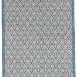 Full size Avesta Rug in Blue, a blue lattice pattern on a beige field with small orange heart accents. 