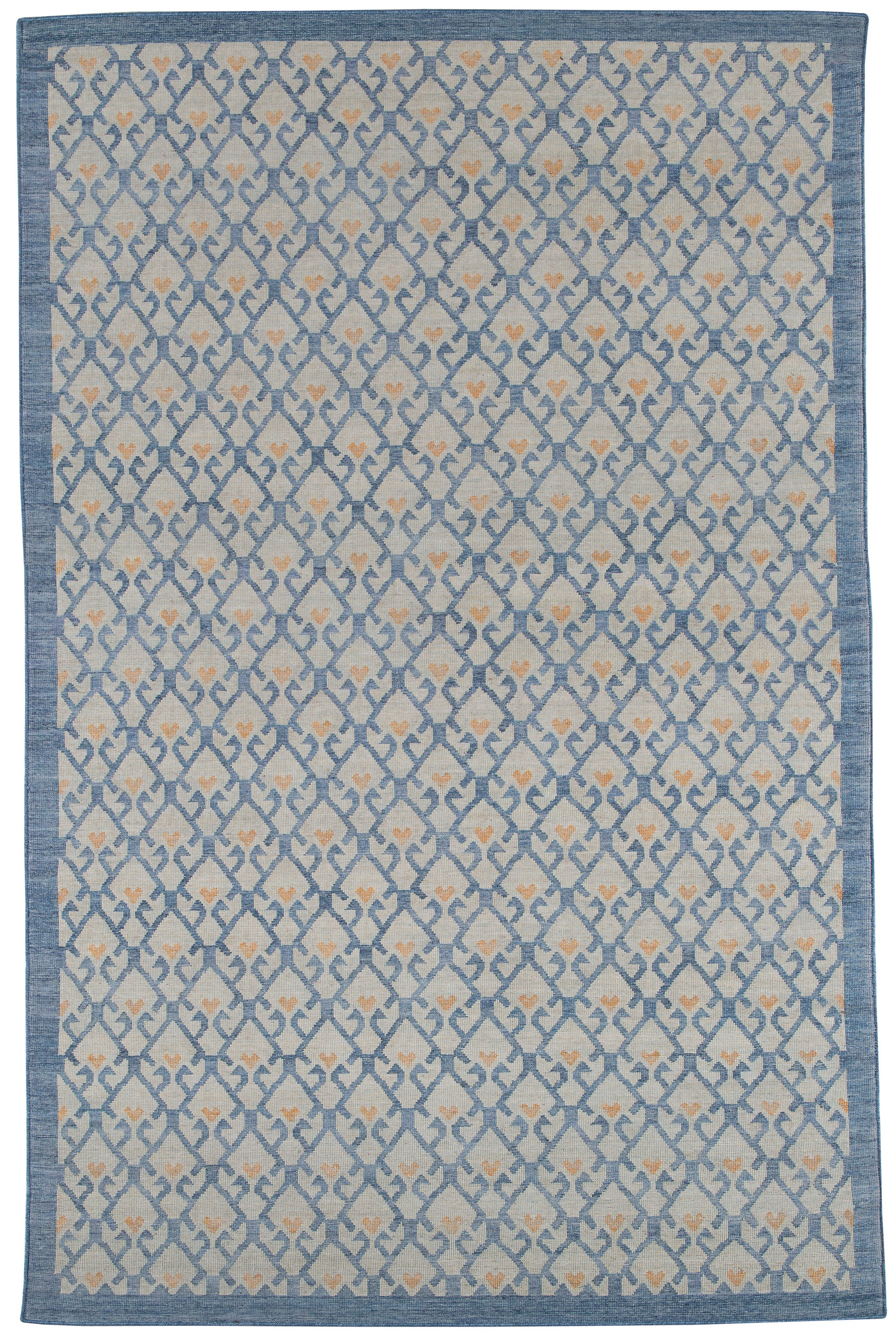 Full size Avesta Rug in Blue, a blue lattice pattern on a beige field with small orange heart accents. 