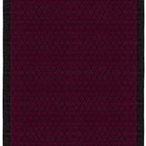 Full size Bucky Rug in berry, features a wide black border with a wine colored lattice field with a metallic sheen. 