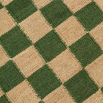 Detail of the Checkerboard Rug in Pawn, a green and tan checkered pattern. 