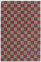 Detail of the Checkerboard Rug in Pawn, a red and sky blue checkered pattern. 