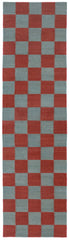 Detail of the Checkerboard Rug in Pawn, a red and osky blue checkered pattern. 