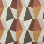 Detail image of a patterned fabric with mixed three dimensional diamond forms with black, white, beige, dark rust red, warm orange and ochre yellow