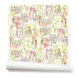 Partially unrolled wallpaper with a pattern of repeating watercolor illustrations of horses, farmers and country houses in green and pink on a white background.