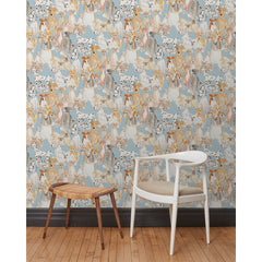 A chair and stool in front of a wall papered in a pattern of many different types of illustrated watercolor dogs with a blue background.