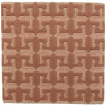 Detail of the Iseo Rug in Conch, a textural monochromatic abstract geometric pattern in terracotta coral color. 