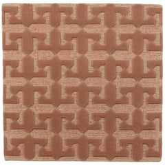 Detail of the Iseo Rug in Conch, a textural monochromatic abstract geometric pattern in terracotta coral color. 