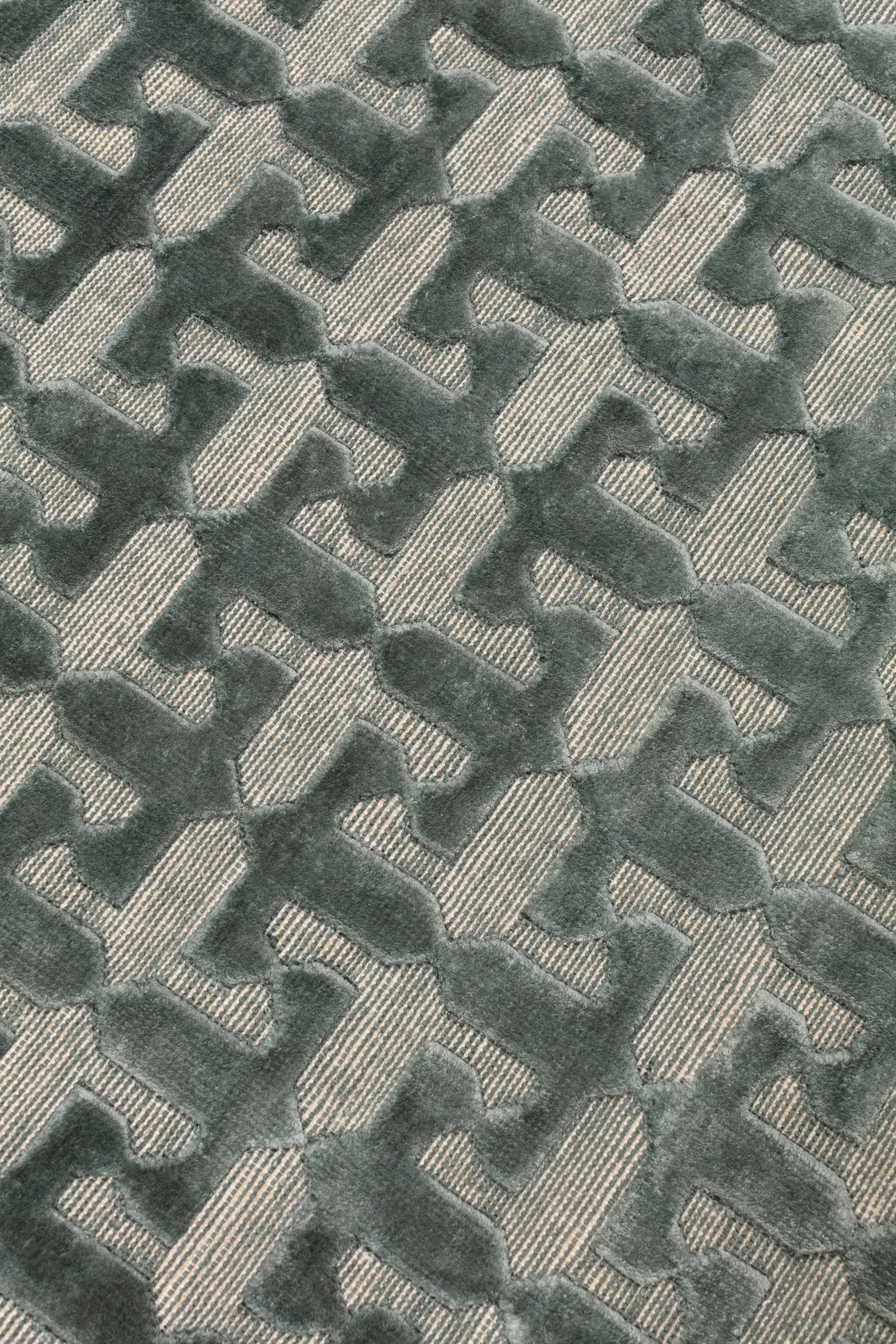 Detail of the Iseo Rug in Winter Sky, a textural monochromatic abstract geometric pattern in slate grey. 