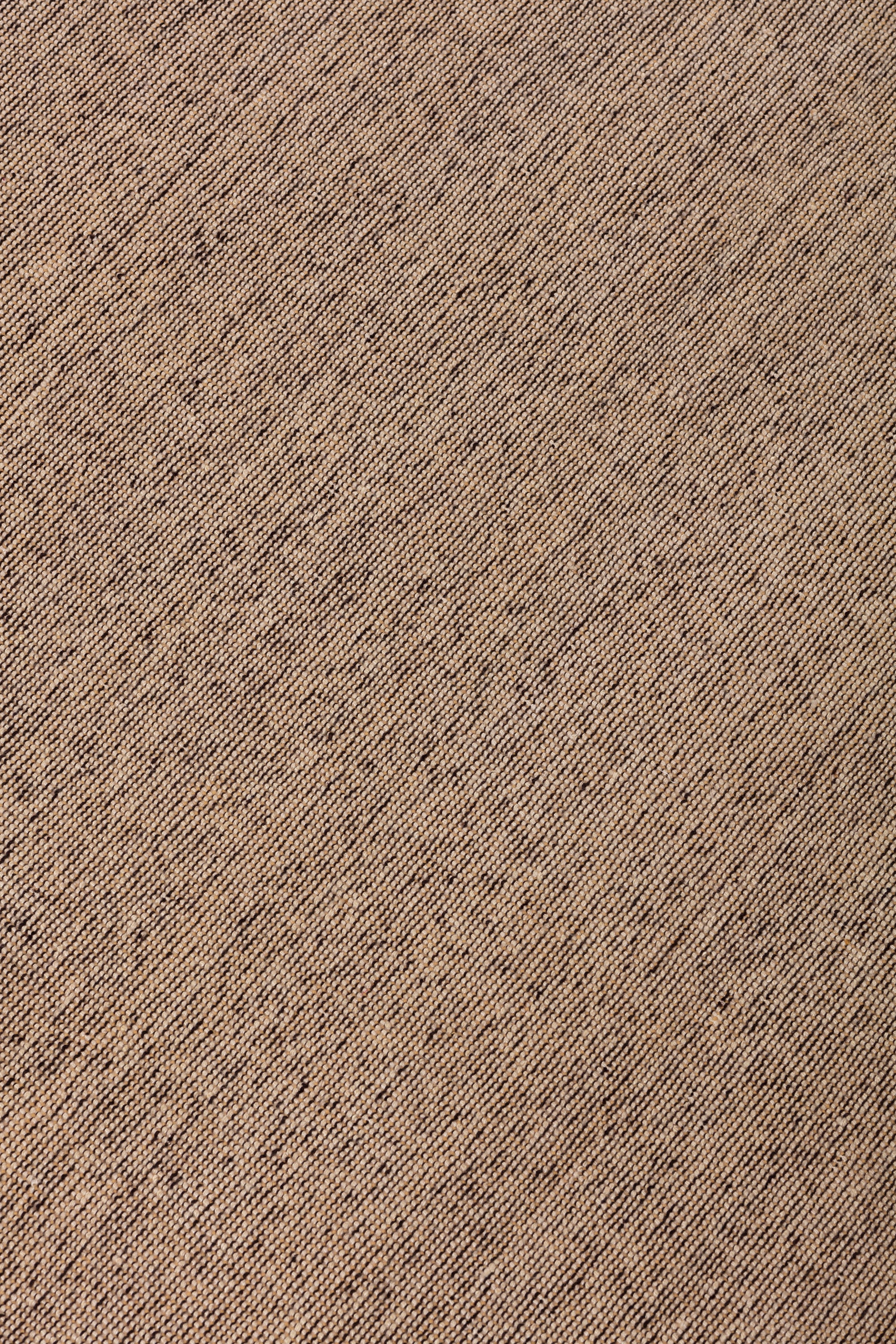 Detail of the Penta Rug in Pebble, a subtle striated pattern in warm taupe. 