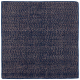 Detail of the Penta Rug in Tempestl, a subtle striated pattern in indigo blue and taupe. 